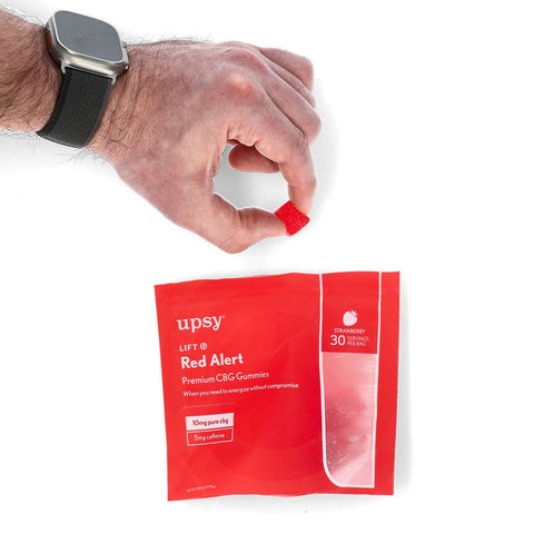 UPSY Wellness | LIFT Red Alert CBD Gummies Pouch with Hand Holding a Gummy